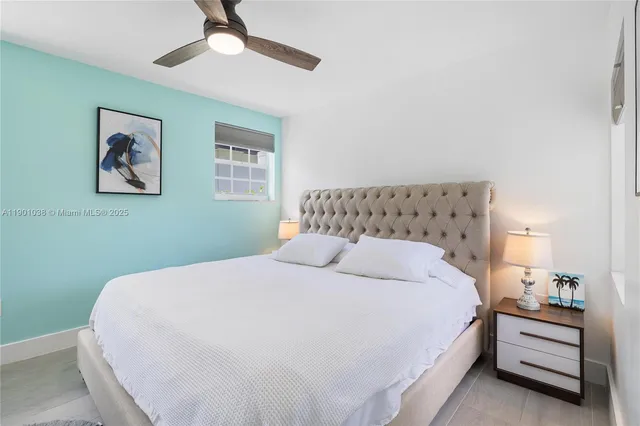 a bedroom with a bed and a painting on the wall