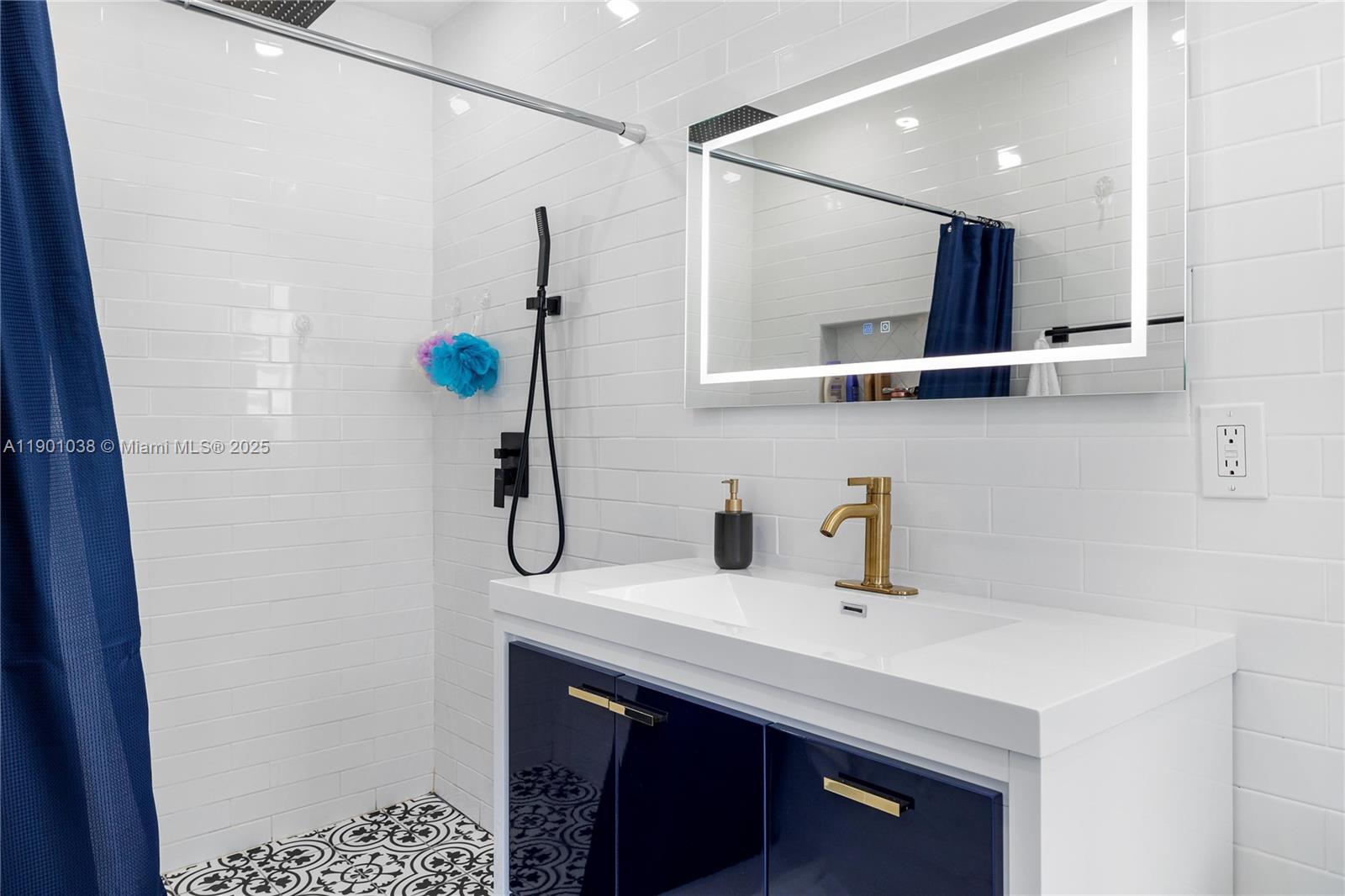 8926 Abbott Avenue Surfside, FL 33154 - Photo 13 of 30 a bathroom with a sink and a mirror