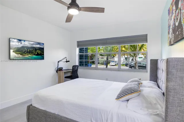 a bed sitting in a bedroom next to a window