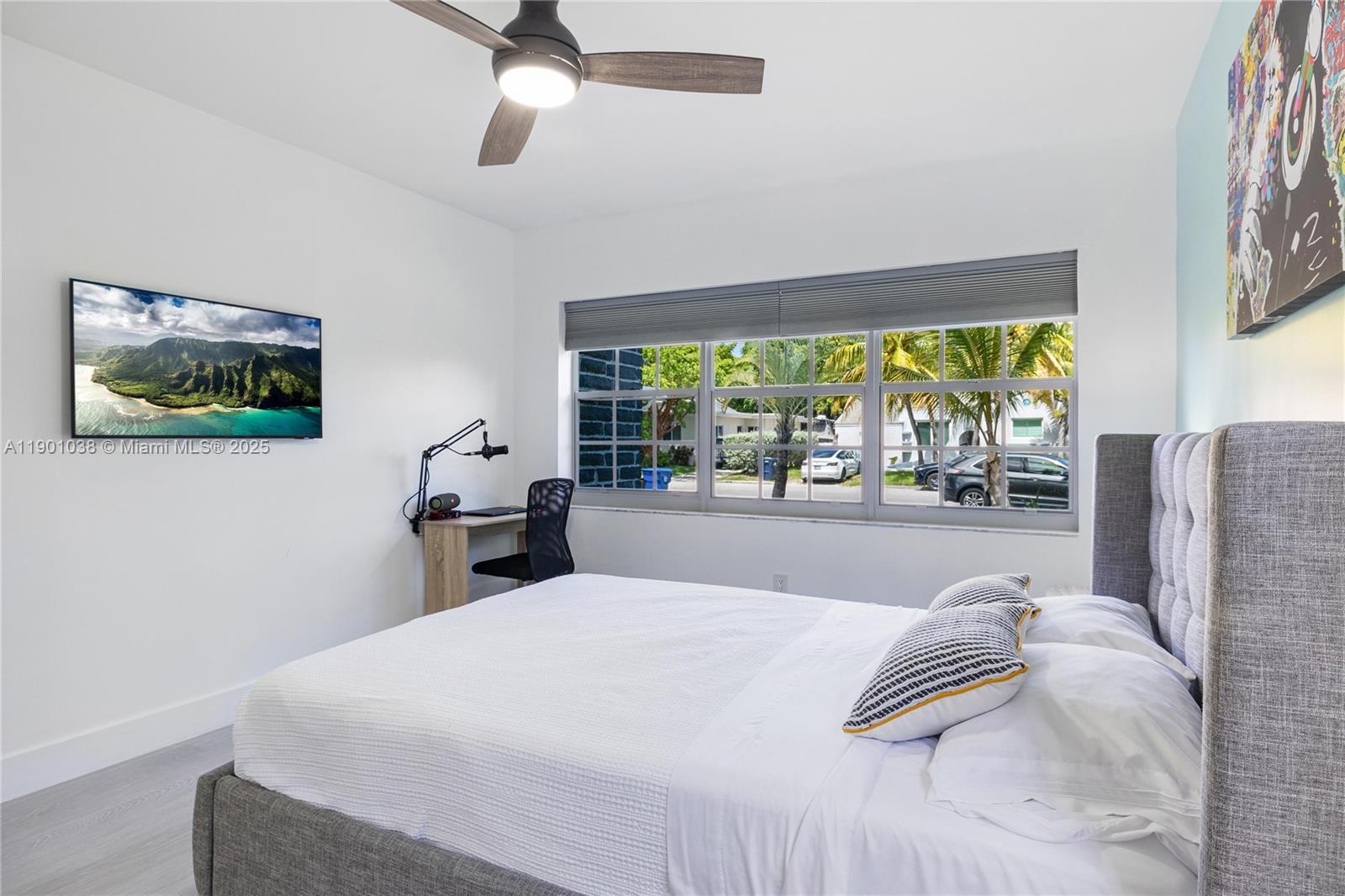 8926 Abbott Avenue Surfside, FL 33154 - Photo 16 of 30 a bed sitting in a bedroom next to a window