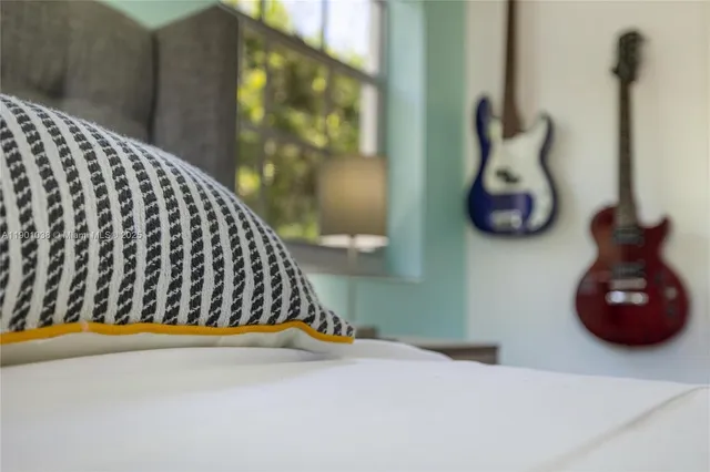 a bedroom with a bed and wall painting