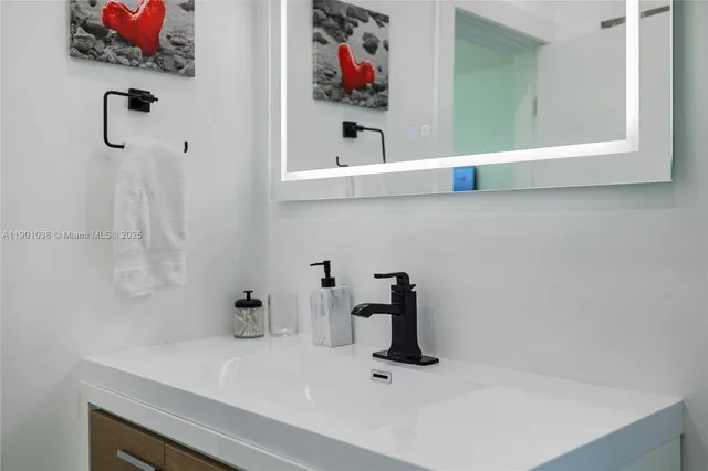 a bathroom with a sink and a mirror