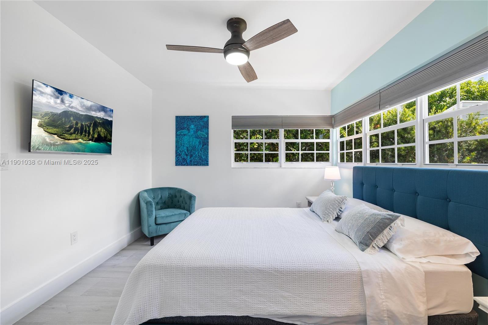 8926 Abbott Avenue Surfside, FL 33154 - Photo 22 of 30 a bedroom with a bed and a large window