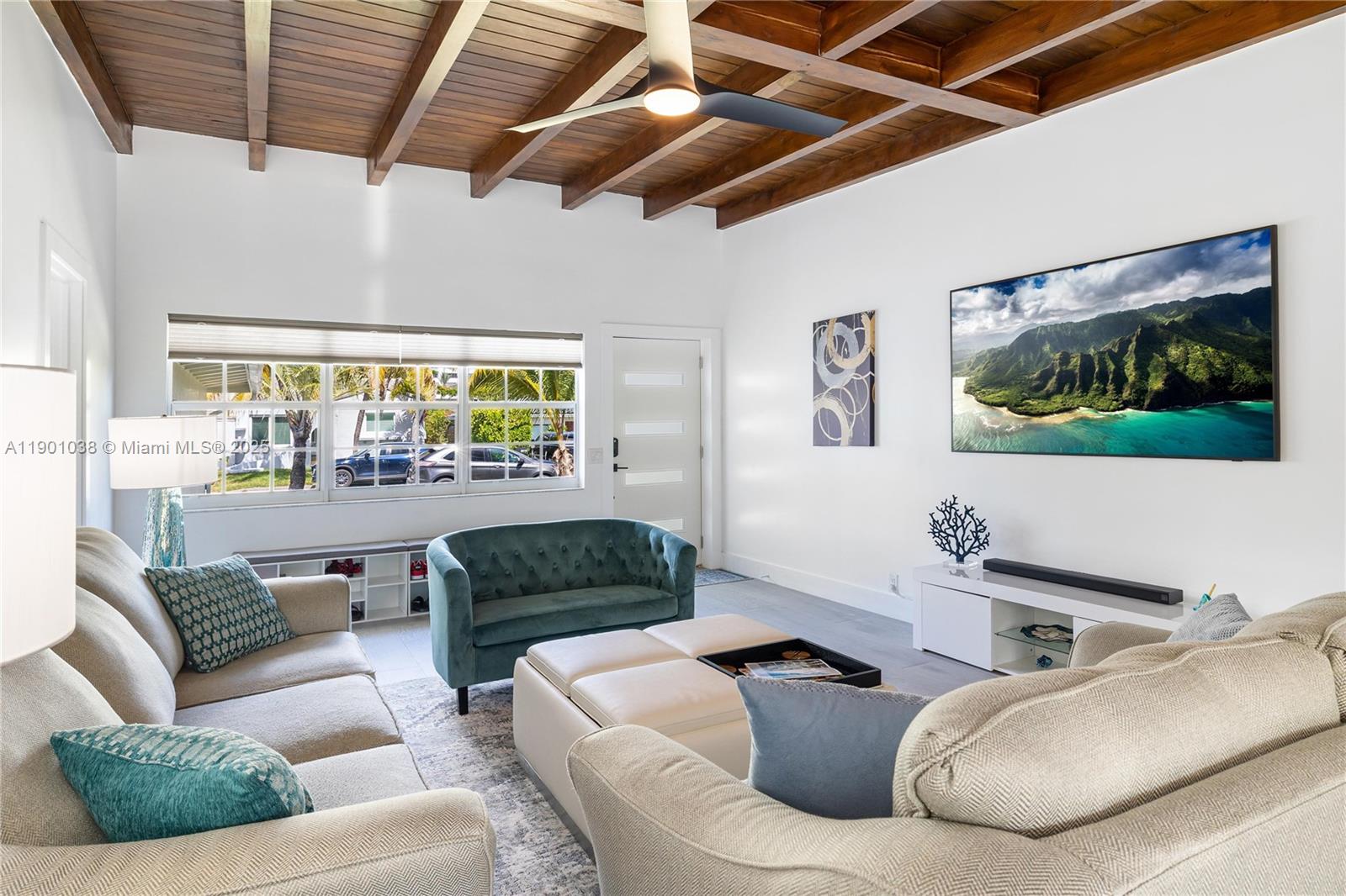 8926 Abbott Avenue Surfside, FL 33154 - Photo 25 of 30 a living room with furniture and a flat screen tv