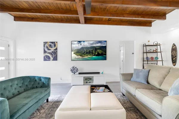 a living room with furniture and a ceiling fan