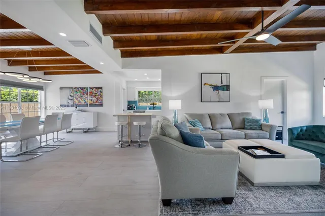 a living room with furniture and a ceiling fan