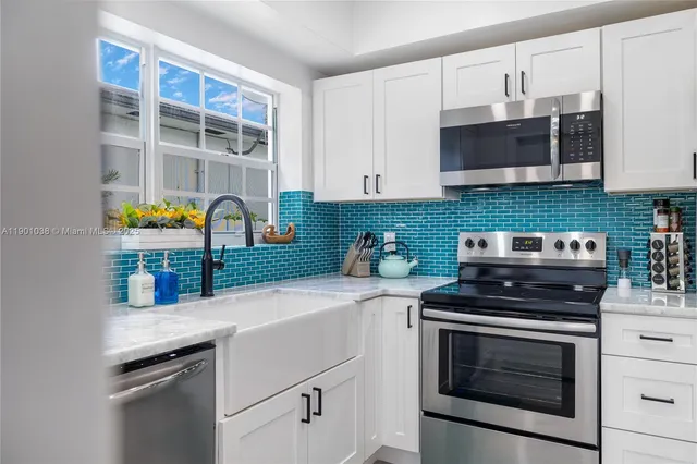 a kitchen with stainless steel appliances a stove a microwave and cabinets