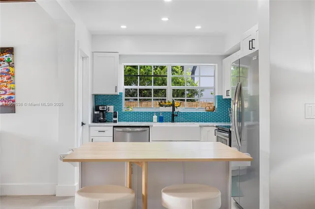 a room with table chairs and entryway