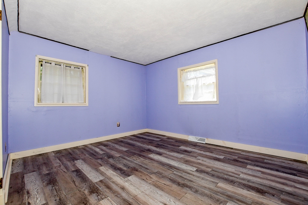 6 Gilbert Way Wareham, MA 02571 - Photo 26 of 41 a view of an empty room with window and wooden floor