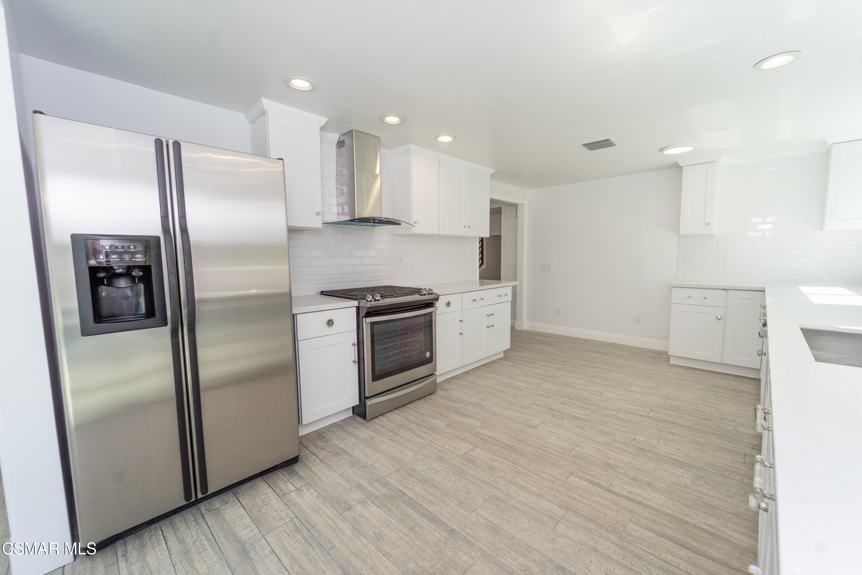 11723 Porter Valley Drive Porter Ranch, CA 91326 - Photo 18 of 64 a kitchen with stainless steel appliances a refrigerator sink and microwave