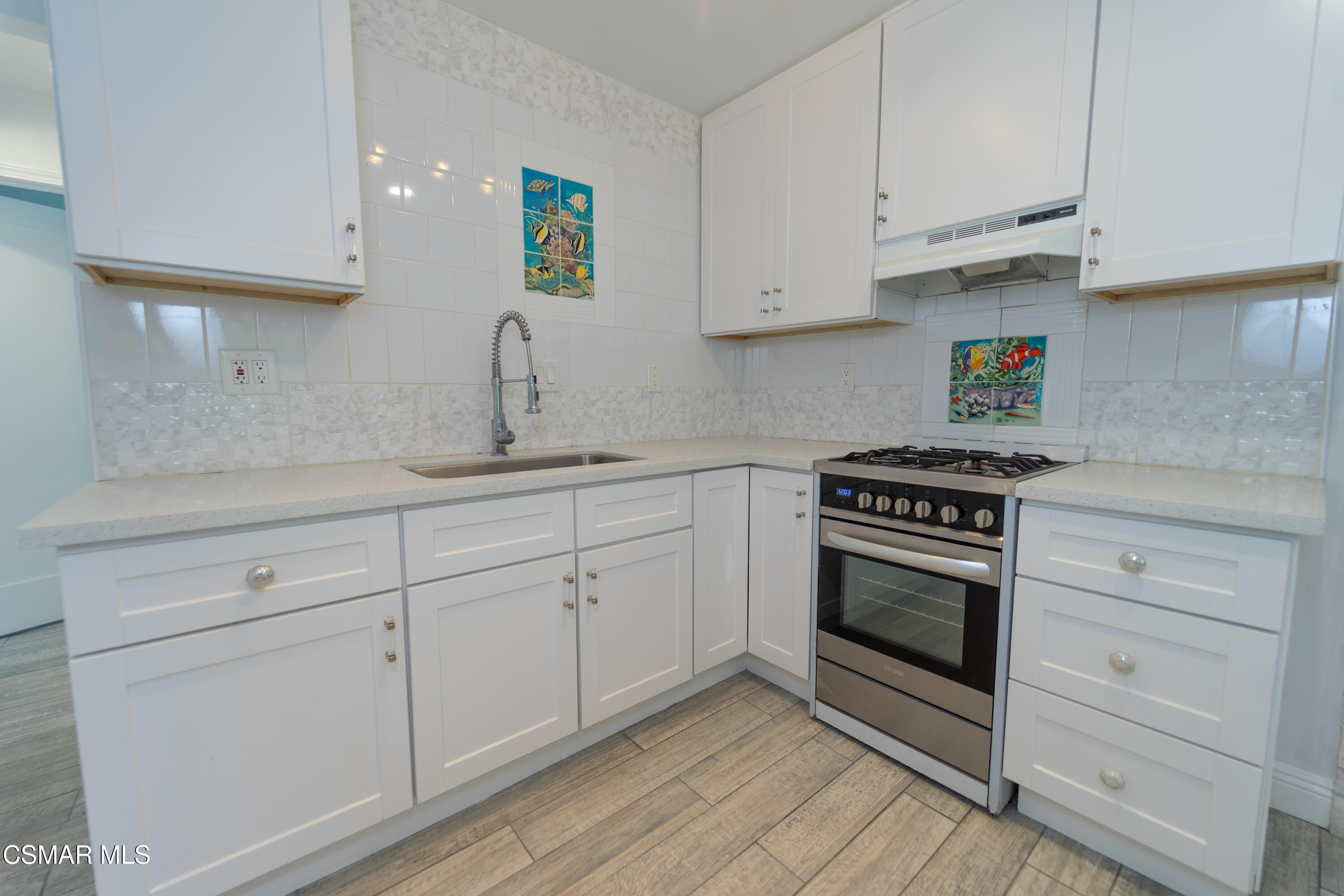 11723 Porter Valley Drive Porter Ranch, CA 91326 - Photo 22 of 64 a kitchen with white cabinets and appliances