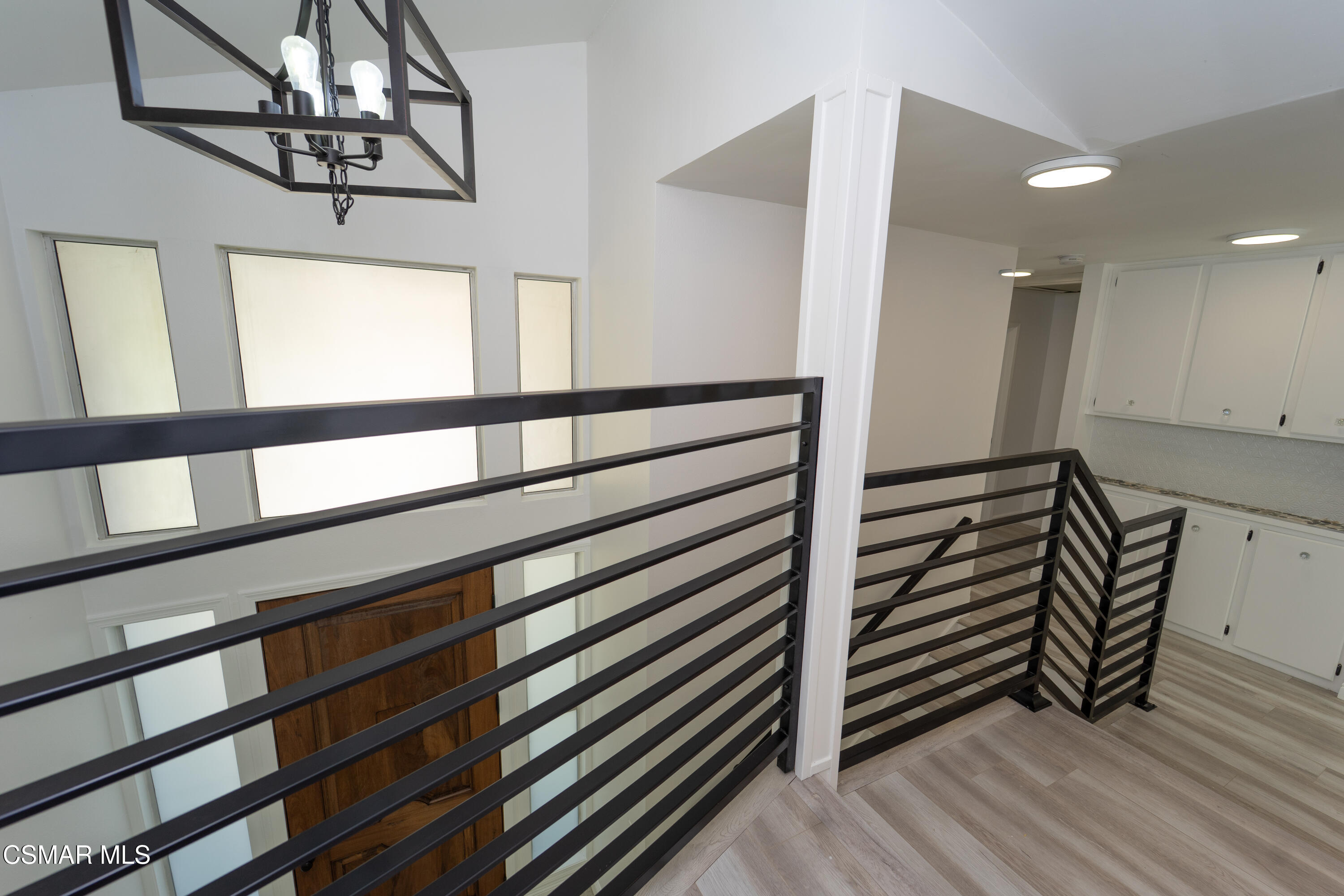 11723 Porter Valley Drive Porter Ranch, CA 91326 - Photo 27 of 64 a view of a hallway with wooden floor and staircase