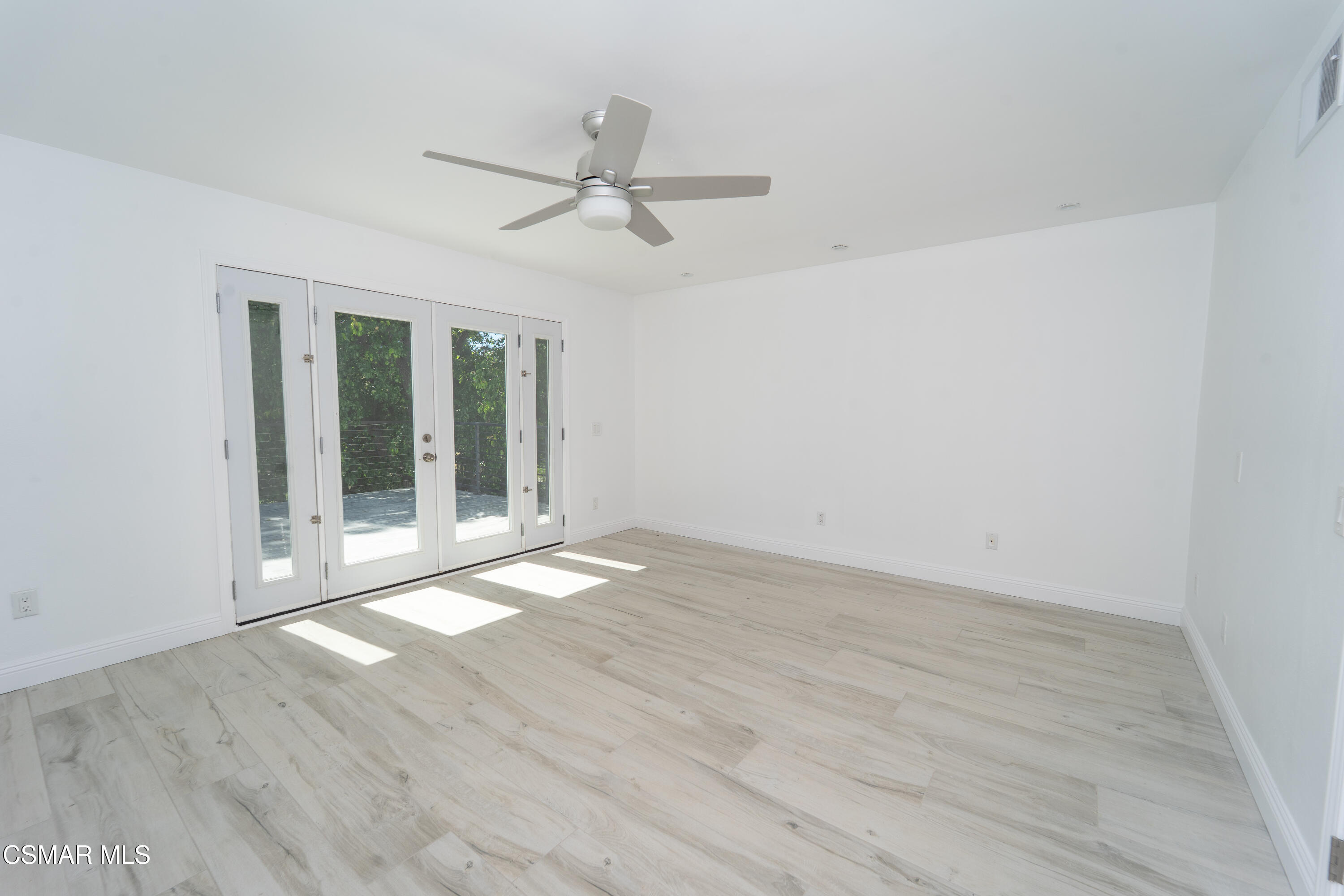11723 Porter Valley Drive Porter Ranch, CA 91326 - Photo 28 of 64 a view of an empty room with wooden floor and a window