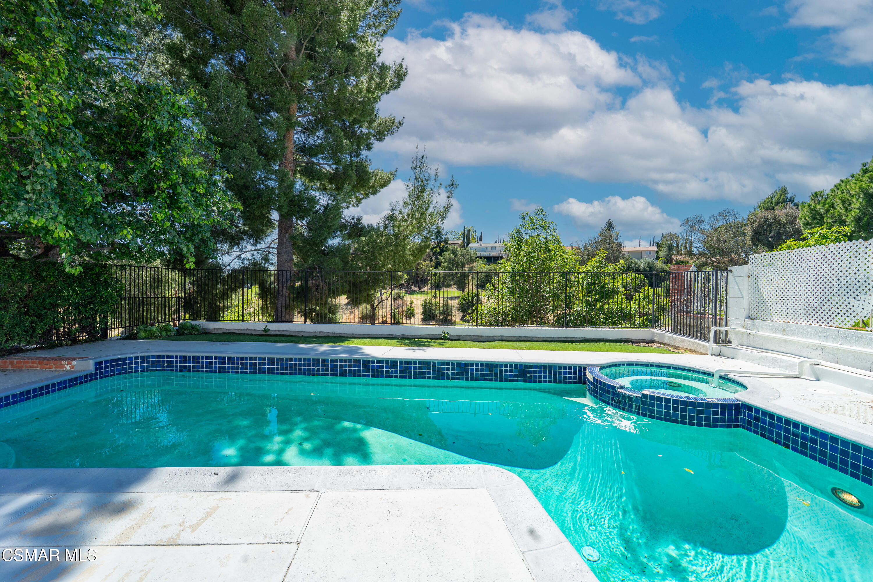11723 Porter Valley Drive Porter Ranch, CA 91326 - Photo 43 of 64 a view of a swimming pool and trees in the background