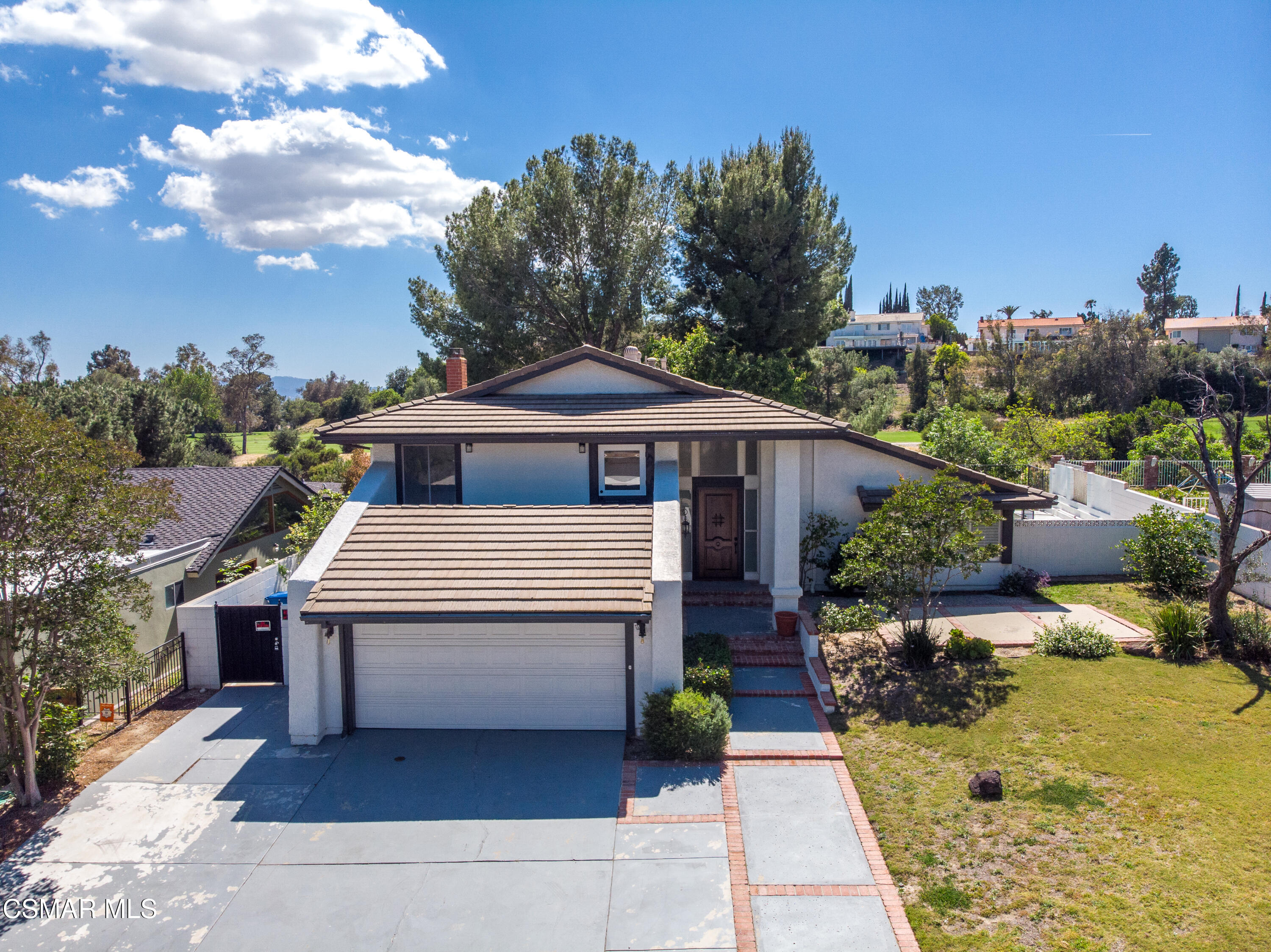 11723 Porter Valley Drive Porter Ranch, CA 91326 - Photo 56 of 64 a front view of a house with a yard