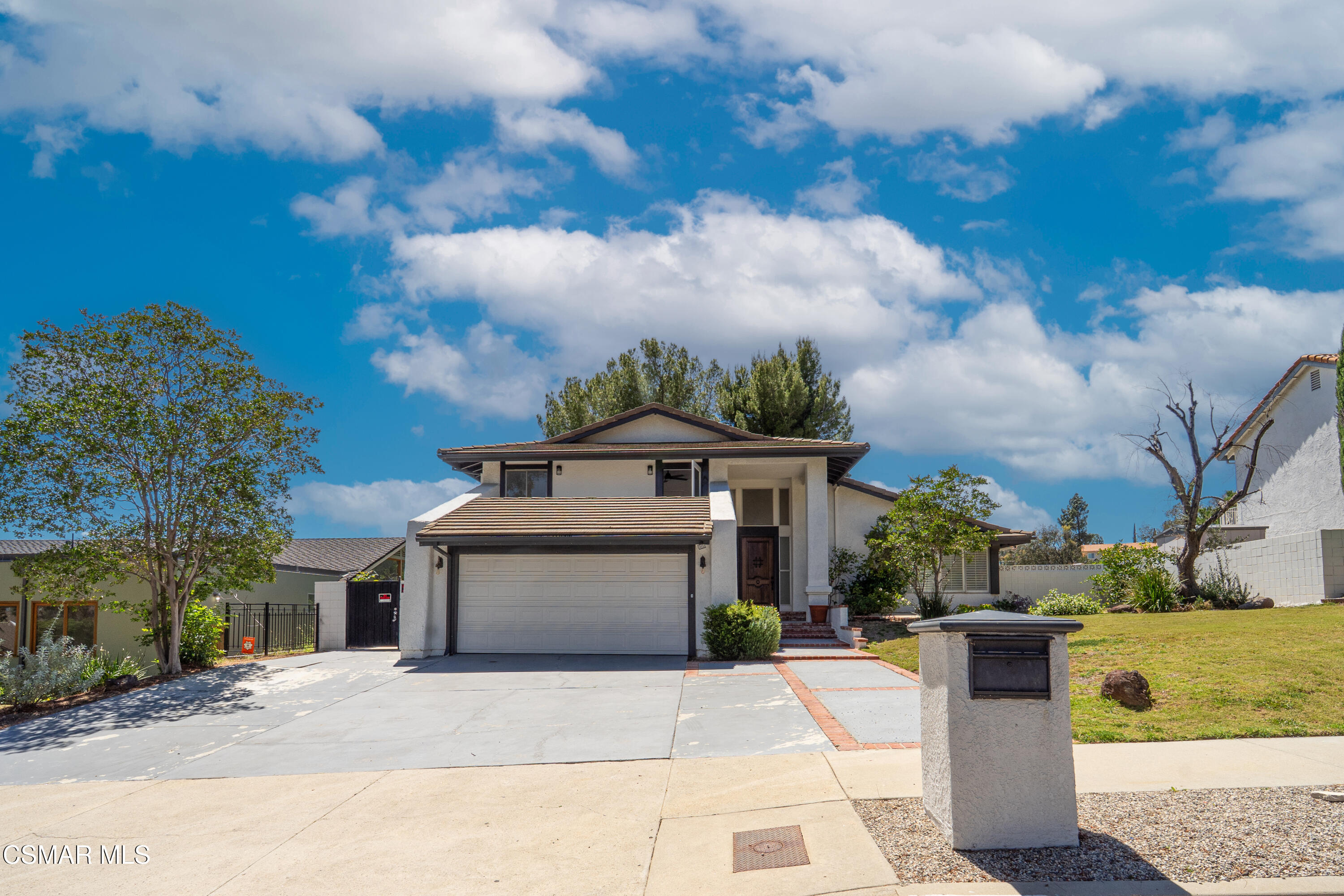 11723 Porter Valley Drive Porter Ranch, CA 91326 - Photo 64 of 64 a front view of a house with a garden