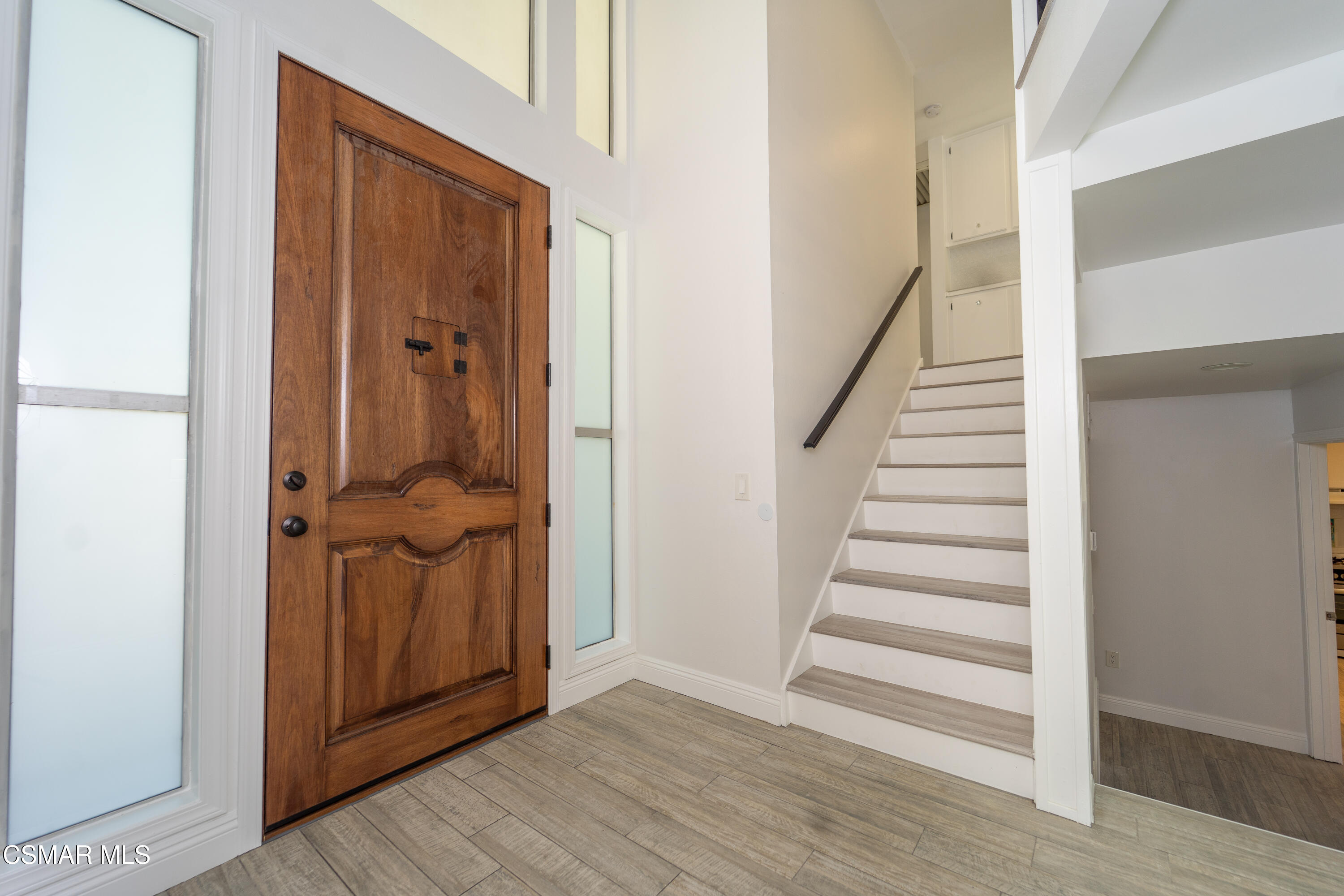 11723 Porter Valley Drive Porter Ranch, CA 91326 - Photo 7 of 64 a view of a hallway with wooden floor and entryway