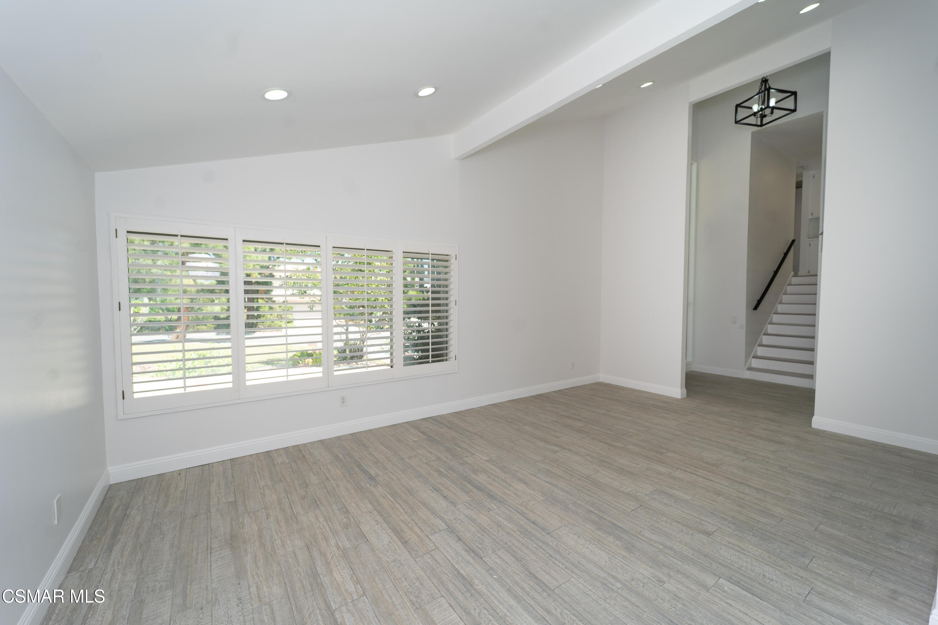 11723 Porter Valley Drive Porter Ranch, CA 91326 - Photo 9 of 64 an empty room with wooden floor and windows