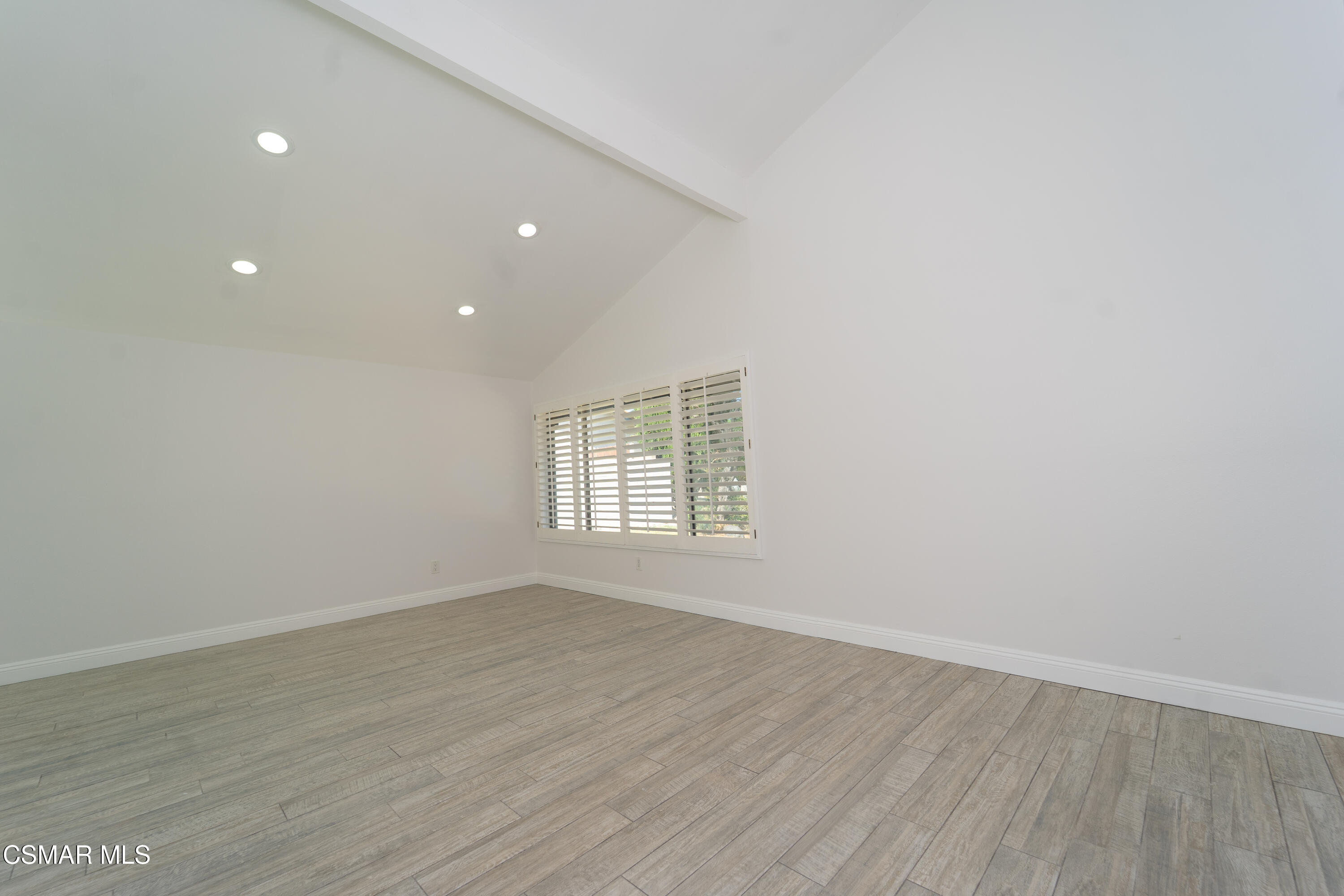 11723 Porter Valley Drive Porter Ranch, CA 91326 - Photo 10 of 64 a view of an empty room with wooden floor and a window