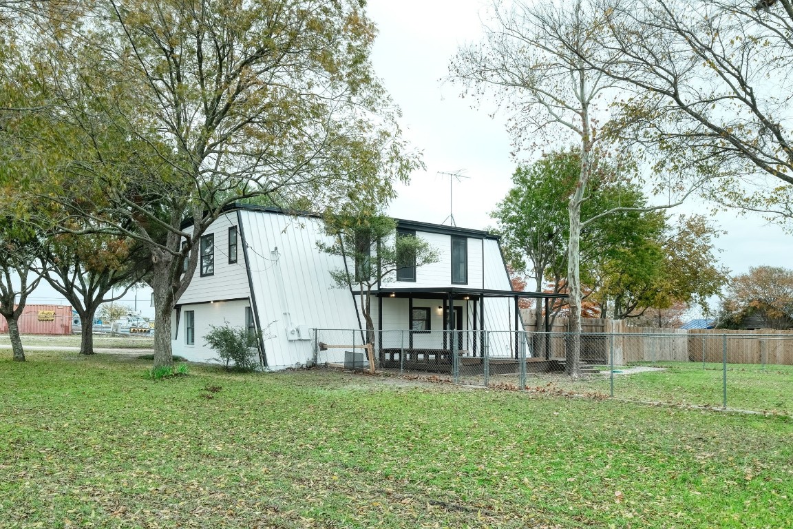 20500 Keilman Lane Pflugerville, TX 78660 - Photo 7 of 36 Back of Main Building showing exterior covered deck. Property extends to the left beyond the metal fence
