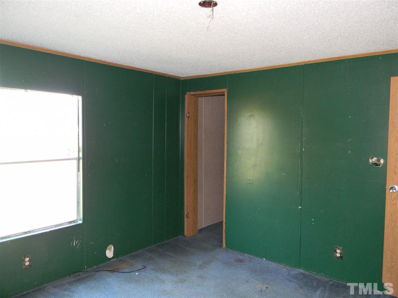 6899 Driver Road Zebulon, NC 27597 - Photo 13 of 16 view of room with window and hallway