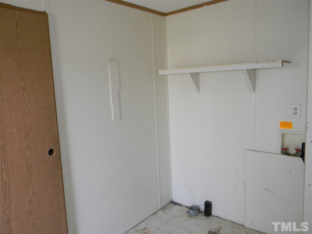 6899 Driver Road Zebulon, NC 27597 - Photo 16 of 16 a view of storage and utility room with empty racks