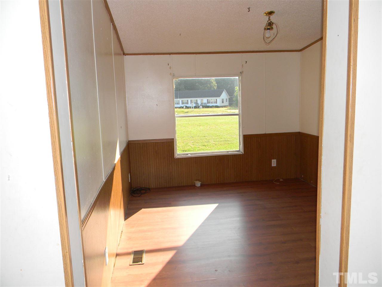 6899 Driver Road Zebulon, NC 27597 - Photo 6 of 16 a view of an empty room and a window