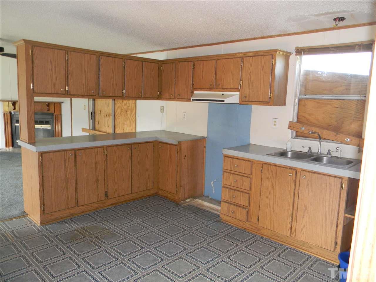 6899 Driver Road Zebulon, NC 27597 - Photo 7 of 16 a kitchen with stainless steel appliances a refrigerator sink and cabinets