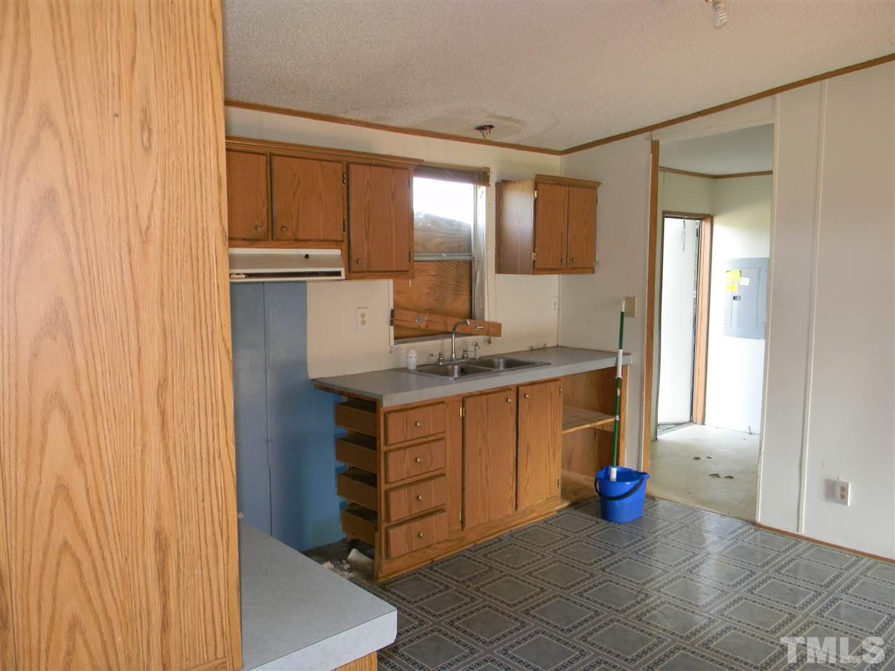 6899 Driver Road Zebulon, NC 27597 - Photo 8 of 16 a kitchen with granite countertop a sink and a stove
