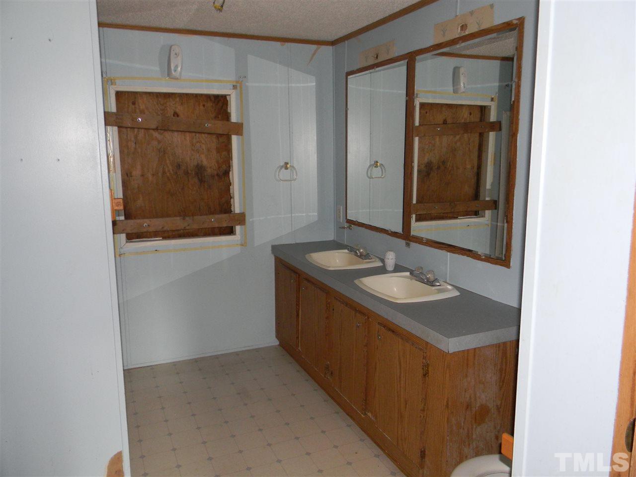 6899 Driver Road Zebulon, NC 27597 - Photo 10 of 16 a bathroom with a sink and a mirror