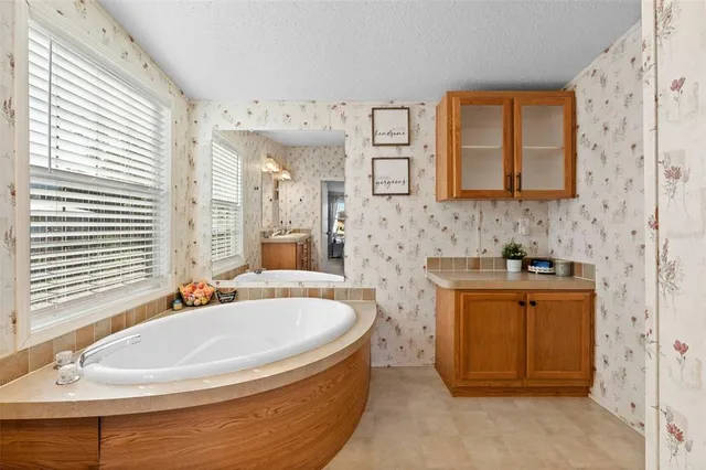 a bath tub sitting in a bathroom next to a sink