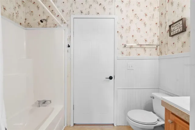 a bathroom with a toilet and a tub