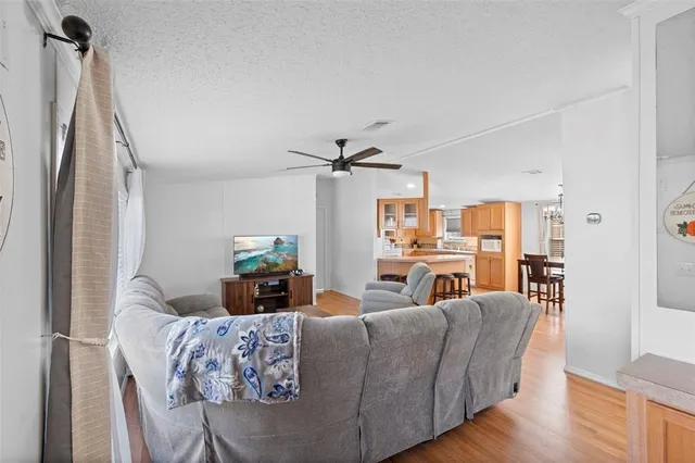 a living room with furniture and a chandelier