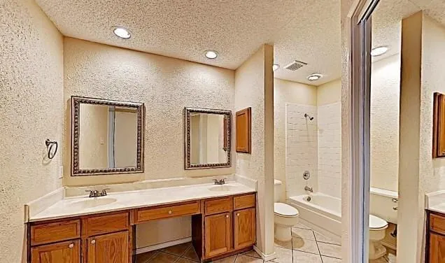 a bathroom with a double vanity sink and mirror with shower