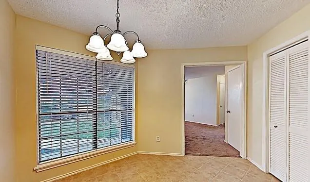 a view of a chandelier fan and a large window