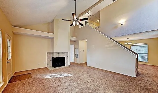 a view of a livingroom with a fireplace and a ceiling fan