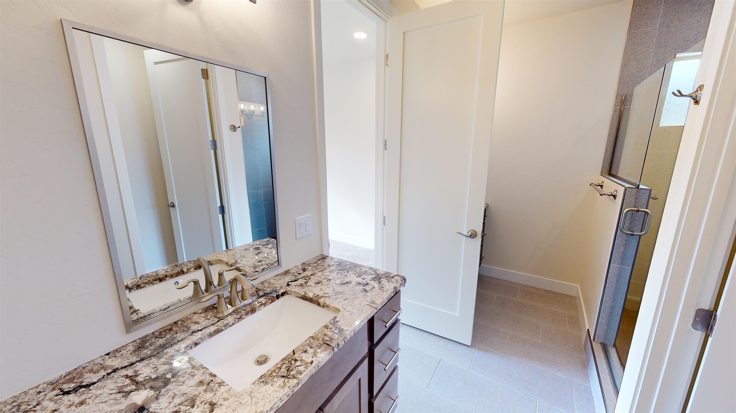 1747 Iron Drive Fruita, CO 81521 - Photo 16 of 30 a bathroom with a granite countertop sink and a mirror
