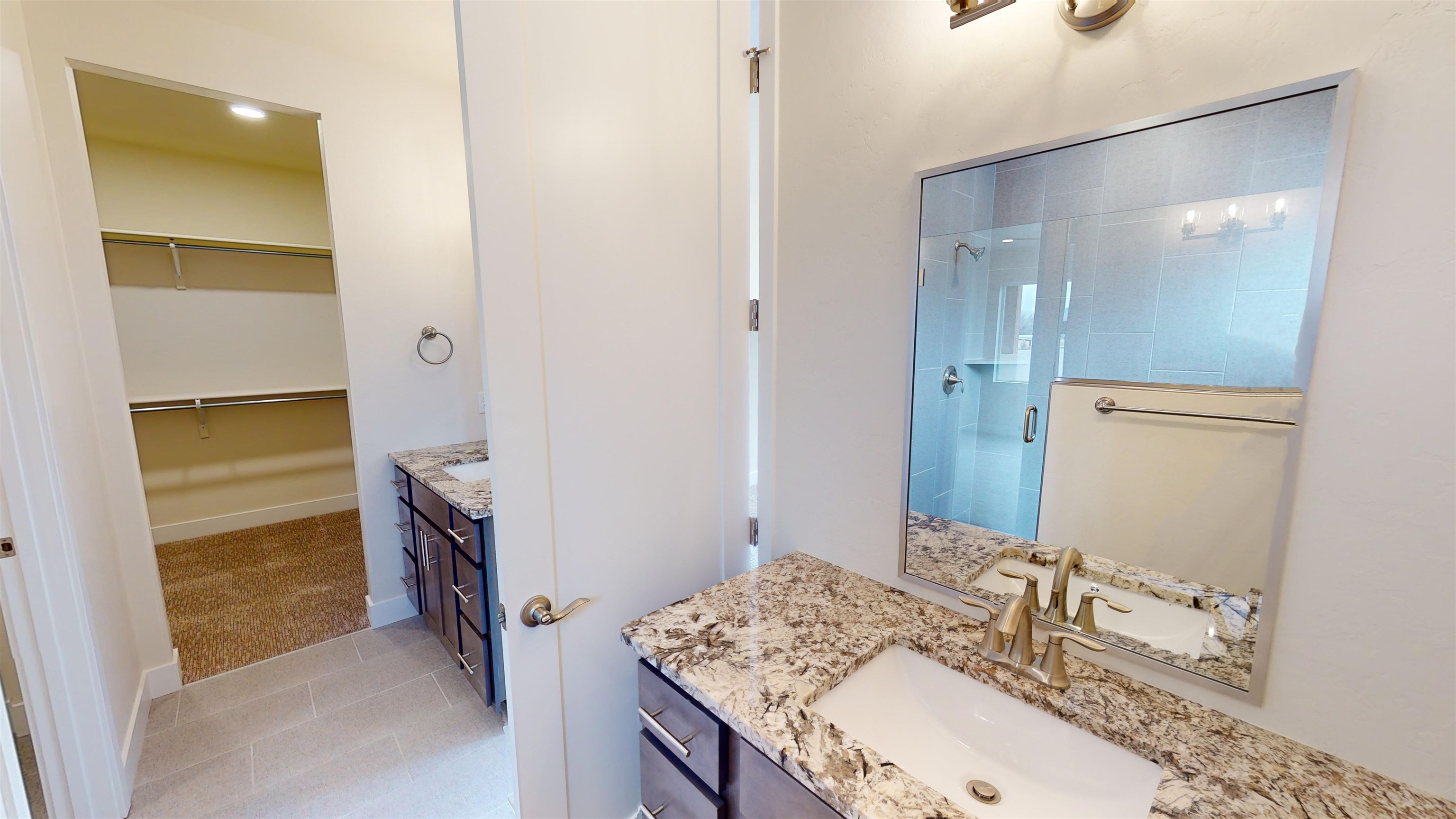 1747 Iron Drive Fruita, CO 81521 - Photo 17 of 30 a bathroom with a granite countertop sink and a mirror
