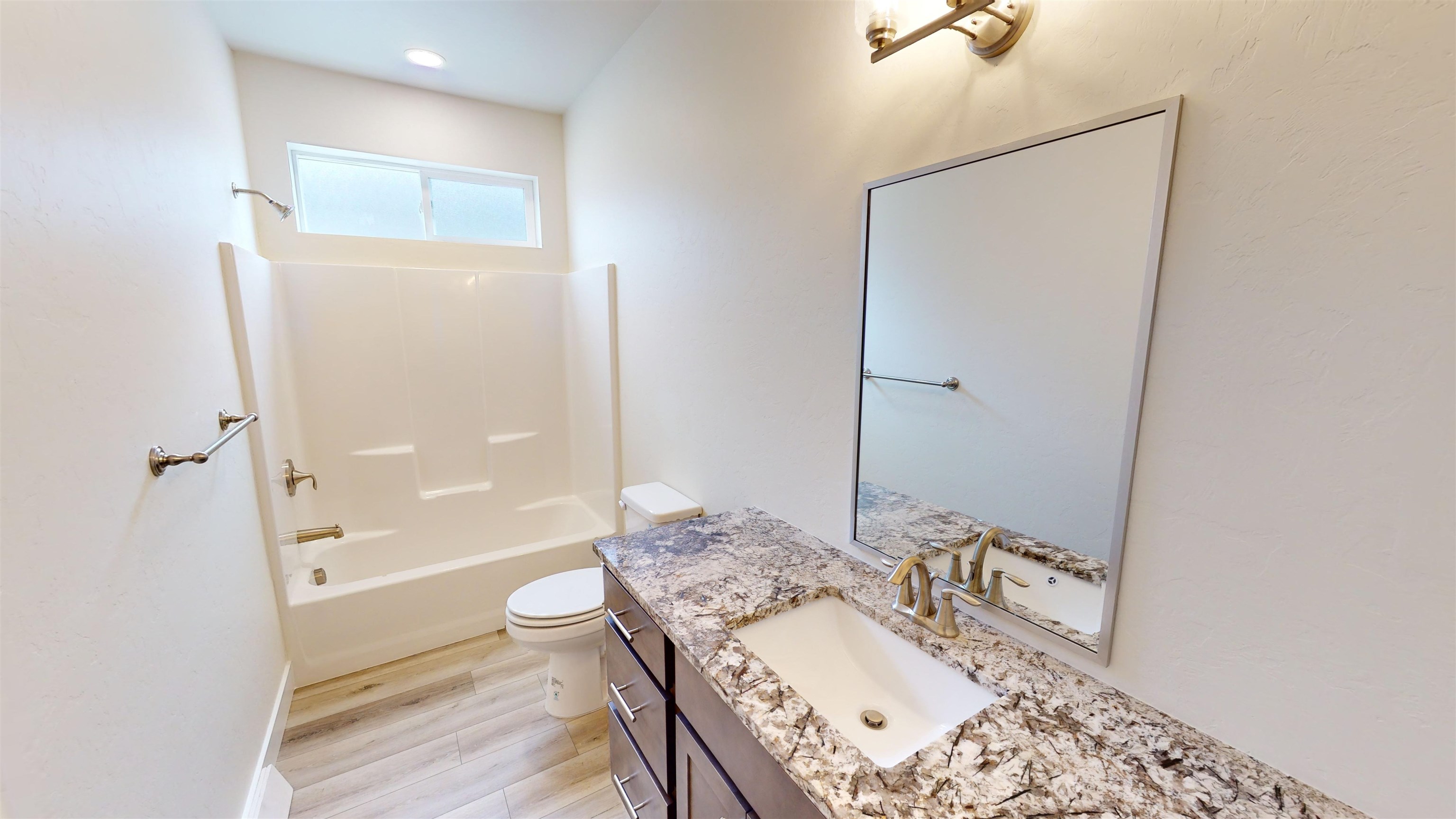 1747 Iron Drive Fruita, CO 81521 - Photo 18 of 30 a bathroom with a granite countertop sink a toilet and shower
