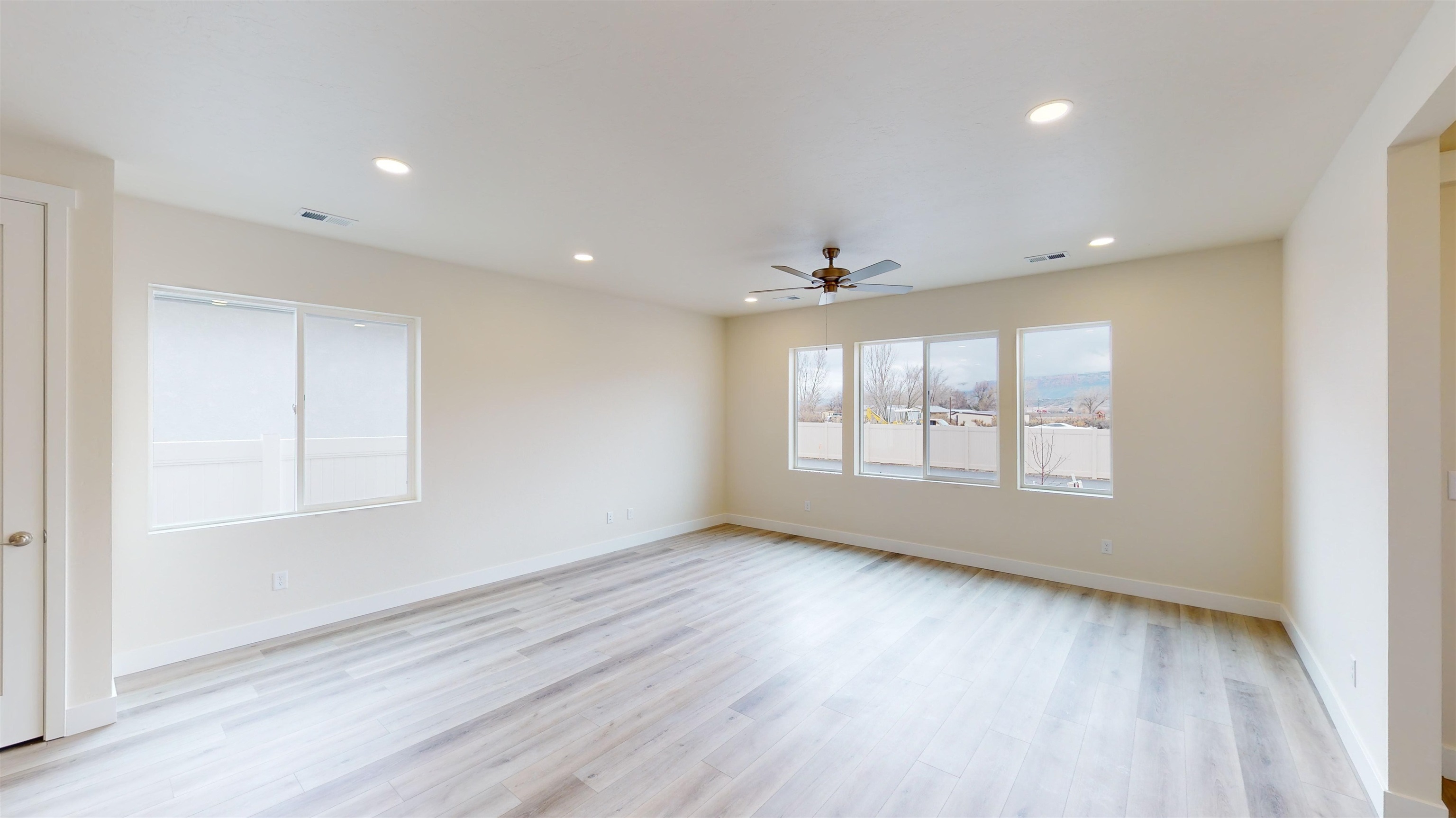 1747 Iron Drive Fruita, CO 81521 - Photo 2 of 30 an empty room with wooden floor and windows