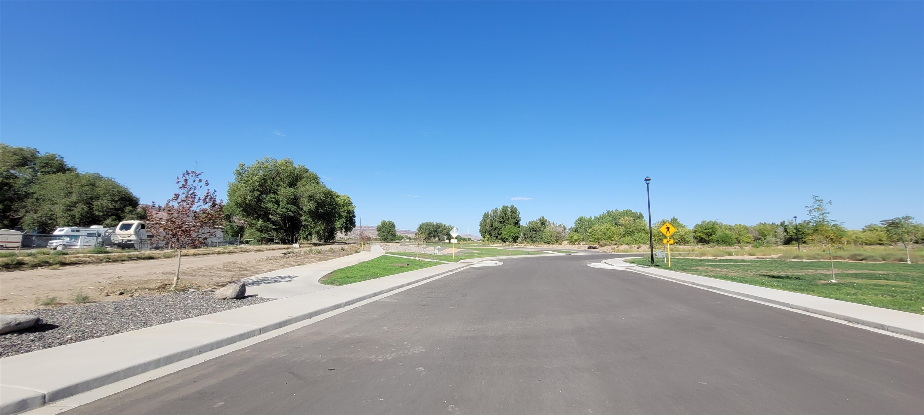 1747 Iron Drive Fruita, CO 81521 - Photo 24 of 30 a view of a road with a yard and fence