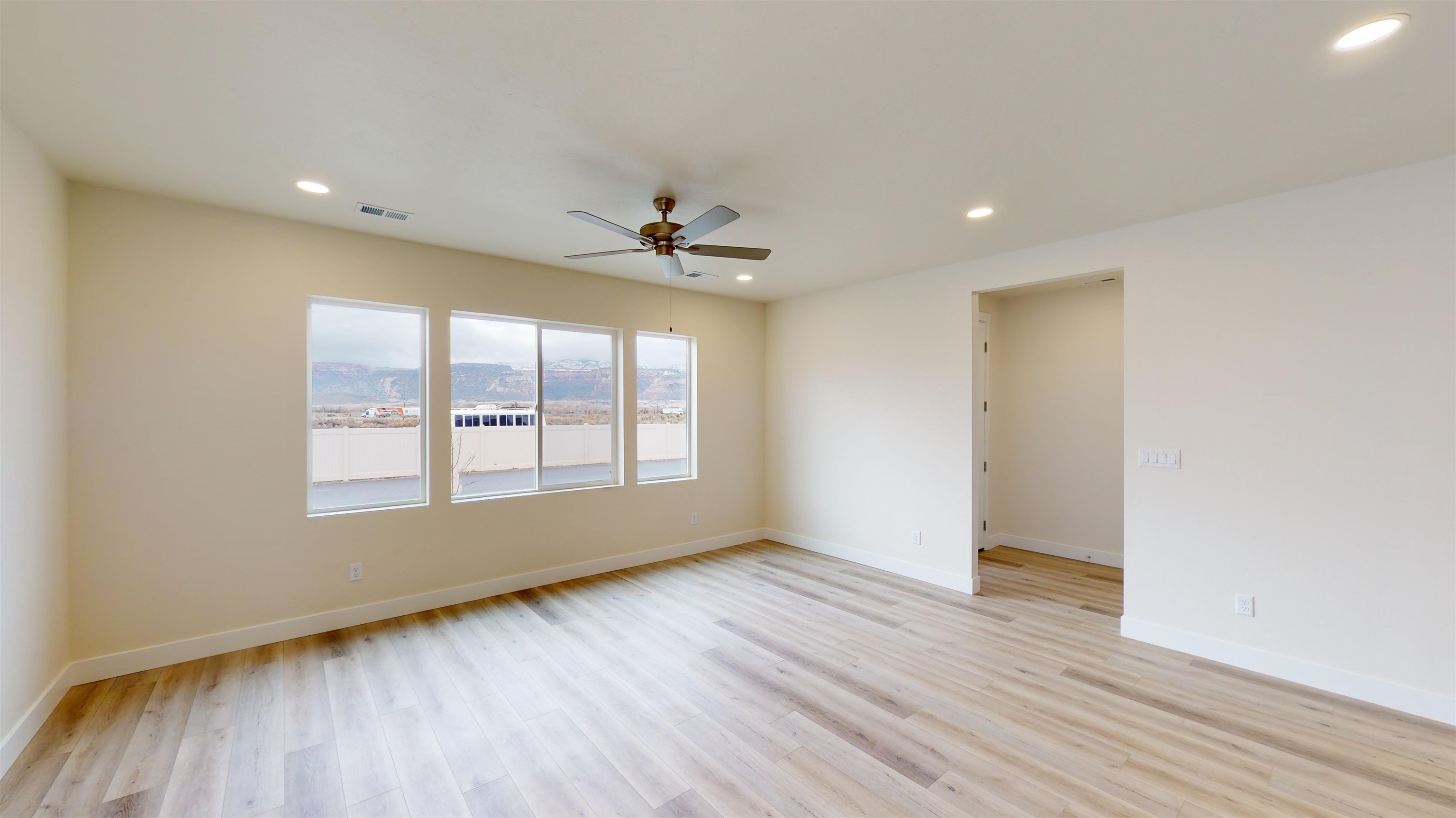 1747 Iron Drive Fruita, CO 81521 - Photo 3 of 30 a view of an empty room with a window and wooden floor