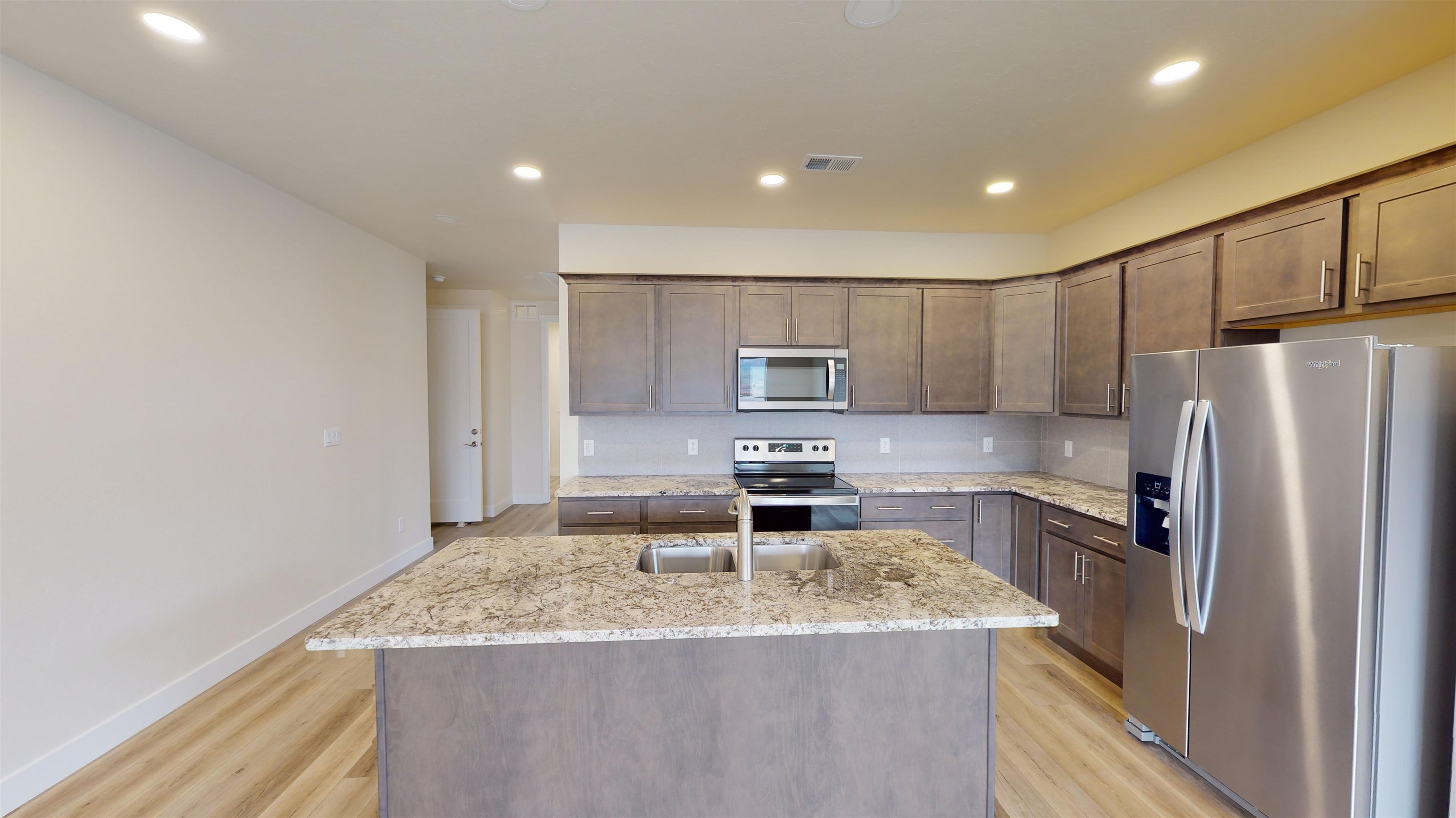 1747 Iron Drive Fruita, CO 81521 - Photo 5 of 30 a kitchen with stainless steel appliances granite countertop a refrigerator a stove and a sink