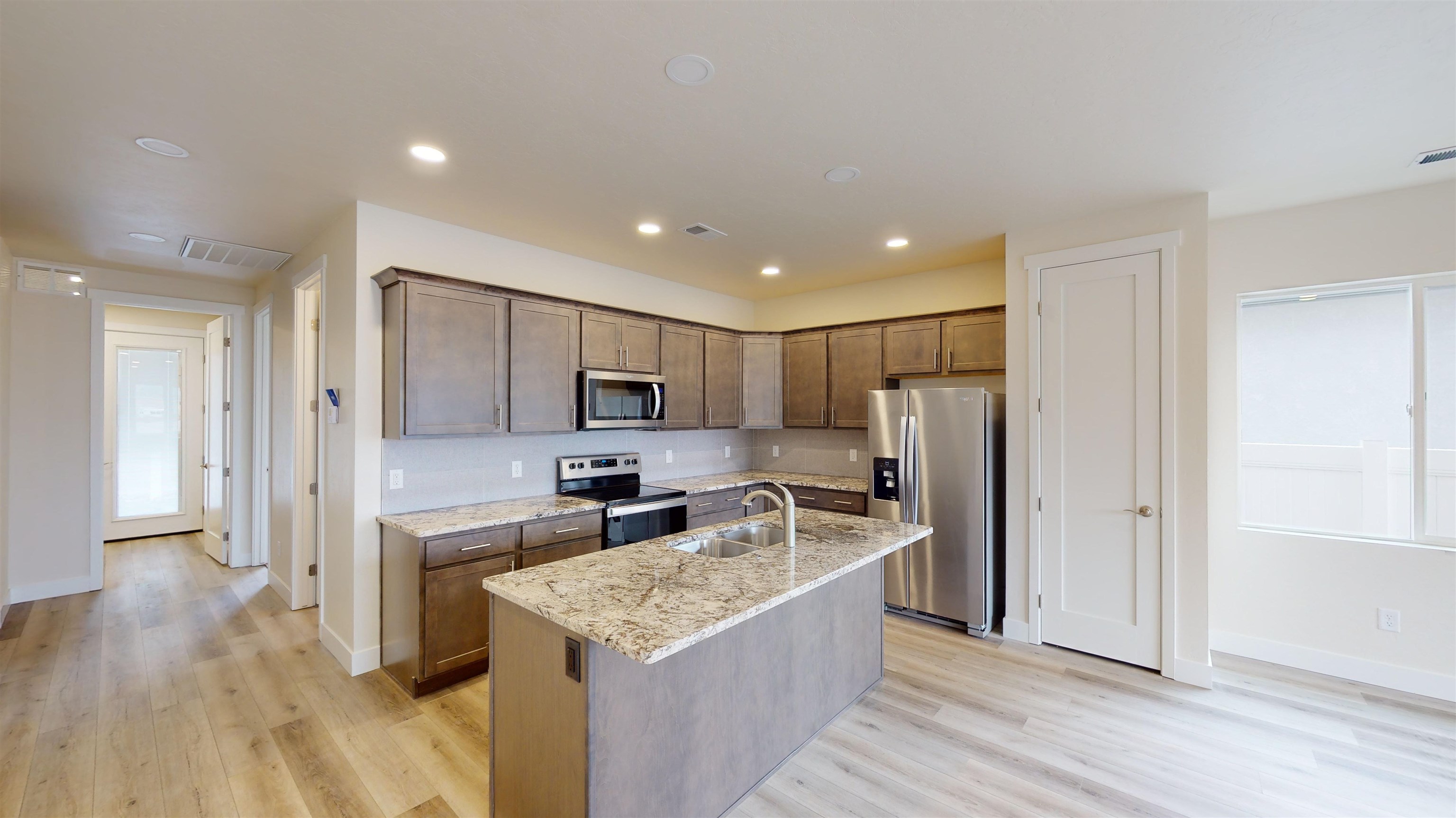 1747 Iron Drive Fruita, CO 81521 - Photo 7 of 30 a kitchen with stainless steel appliances granite countertop a refrigerator a sink a stove and a wooden floors