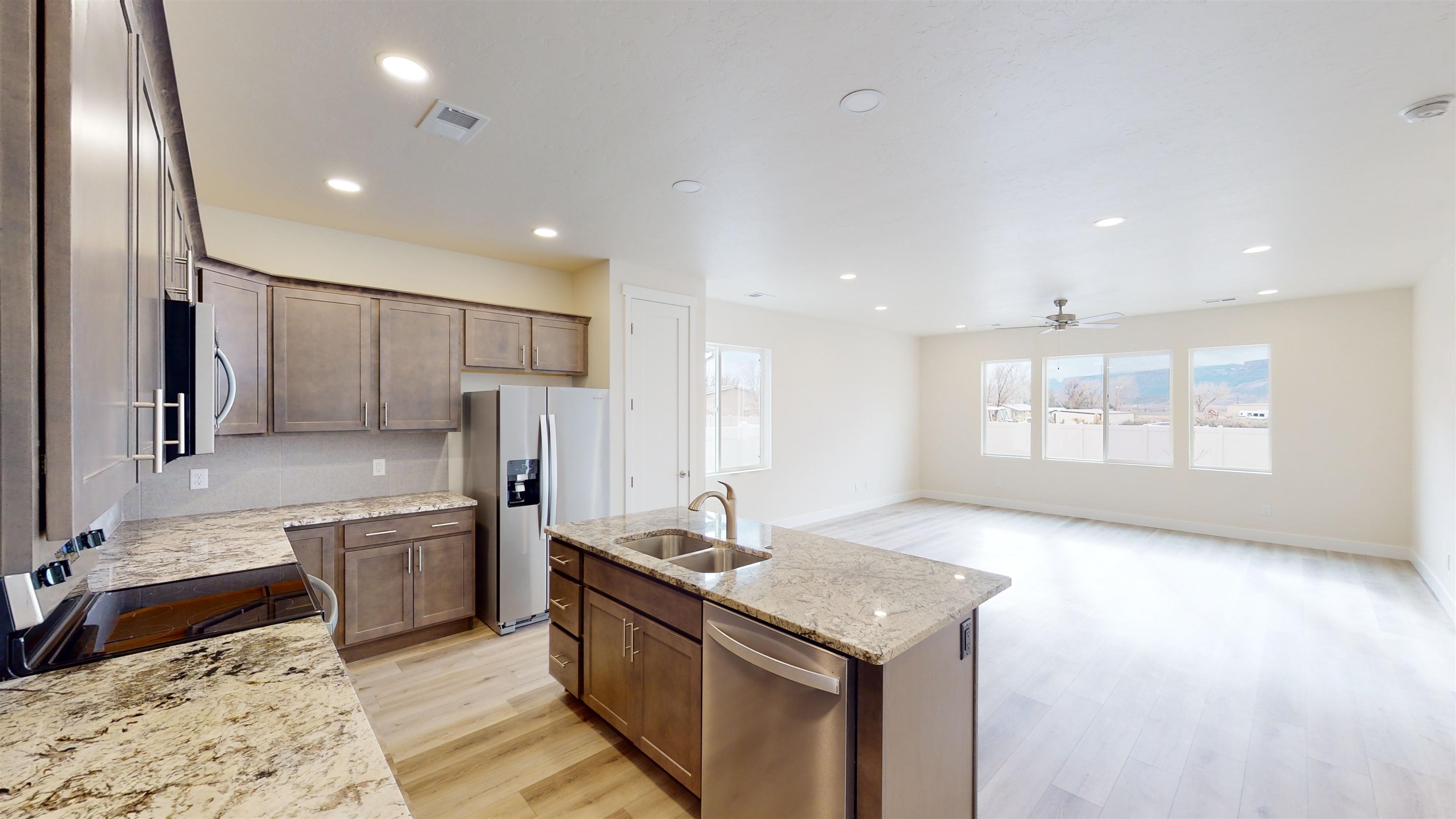 1747 Iron Drive Fruita, CO 81521 - Photo 8 of 30 a kitchen with stainless steel appliances granite countertop a sink stove and refrigerator