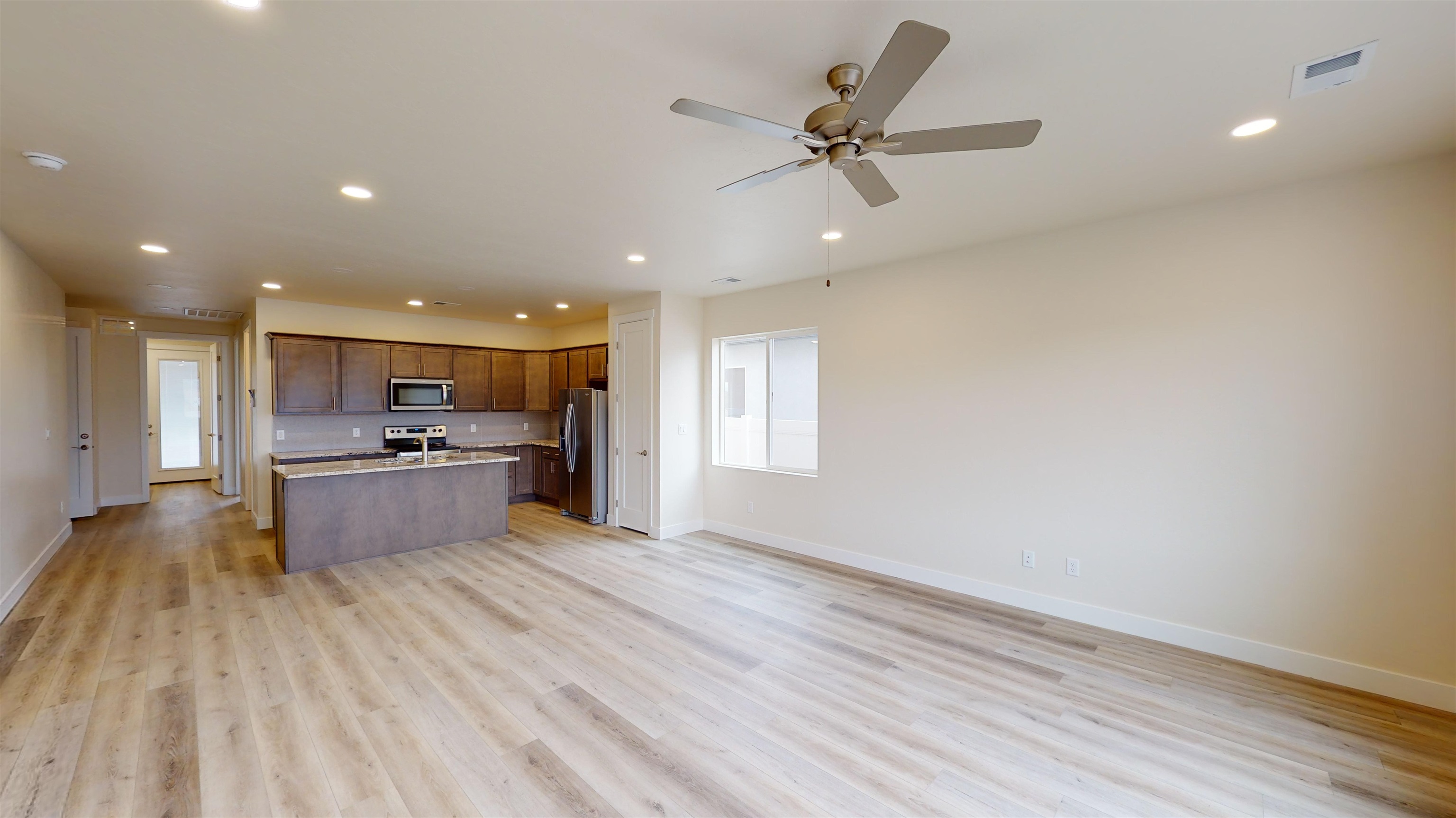 1747 Iron Drive Fruita, CO 81521 - Photo 10 of 30 a large kitchen with a lot of counter space and a ceiling fan