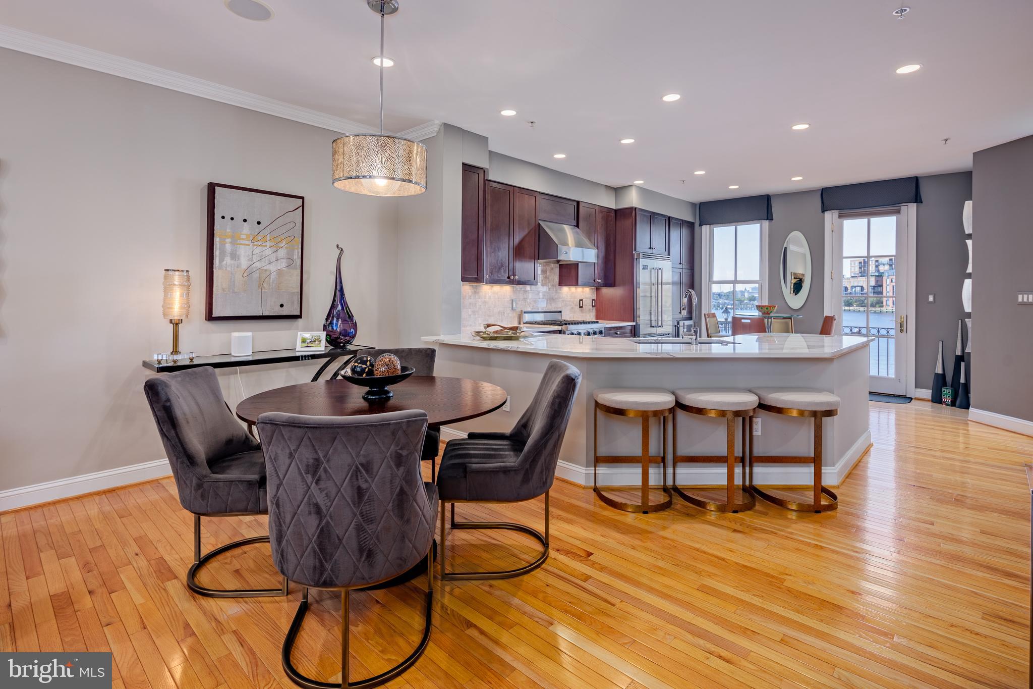 2317 Boston Street, Unit 3 Baltimore, MD 21224 - Photo 17 of 51 a dining hall with stainless steel appliances a dining table and chairs