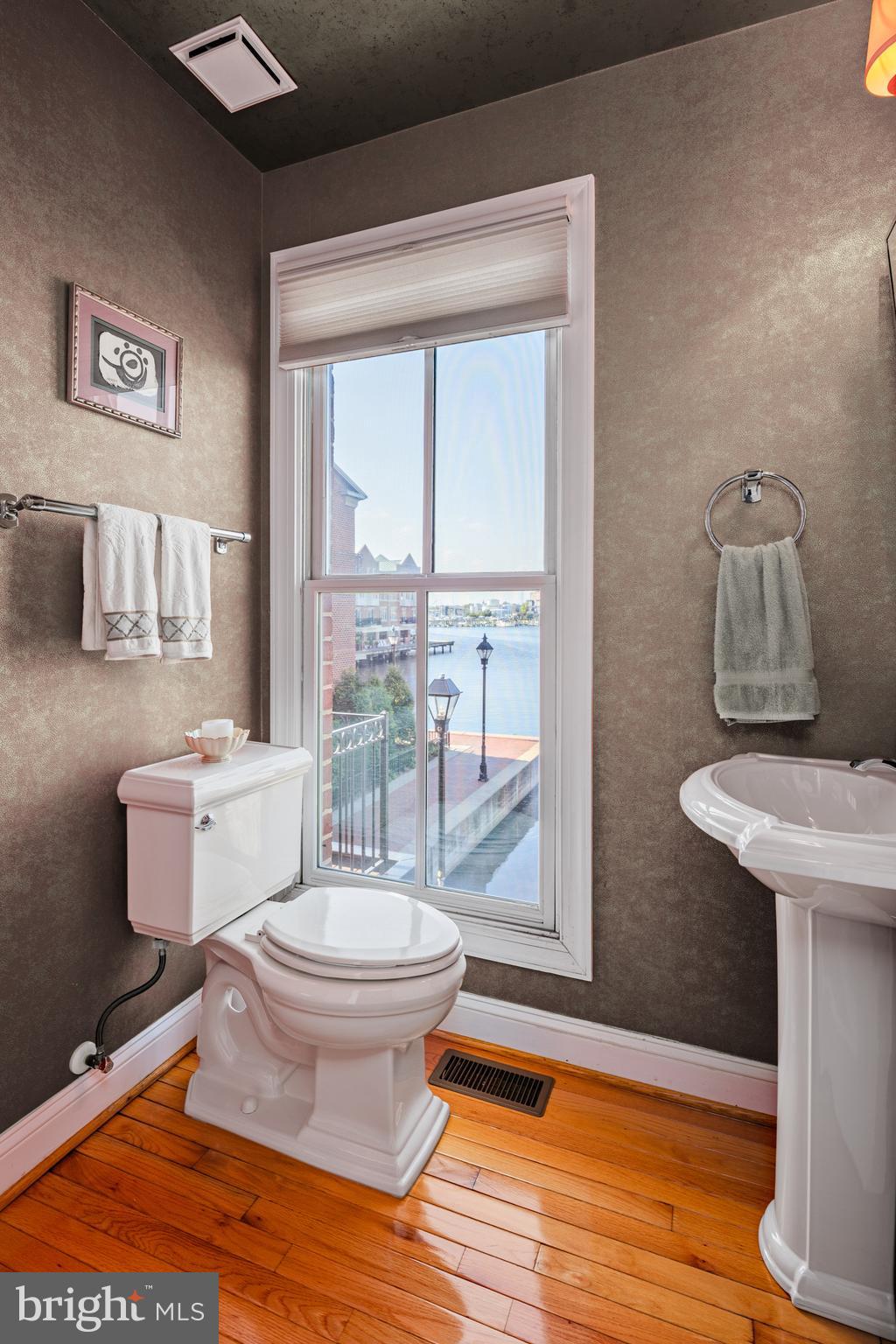 2317 Boston Street, Unit 3 Baltimore, MD 21224 - Photo 18 of 51 a bathroom with a toilet a sink and a mirror