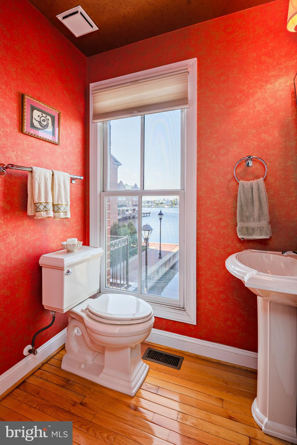 2317 Boston Street, Unit 3 Baltimore, MD 21224 - Photo 19 of 51 a bathroom with a toilet a sink and a mirror