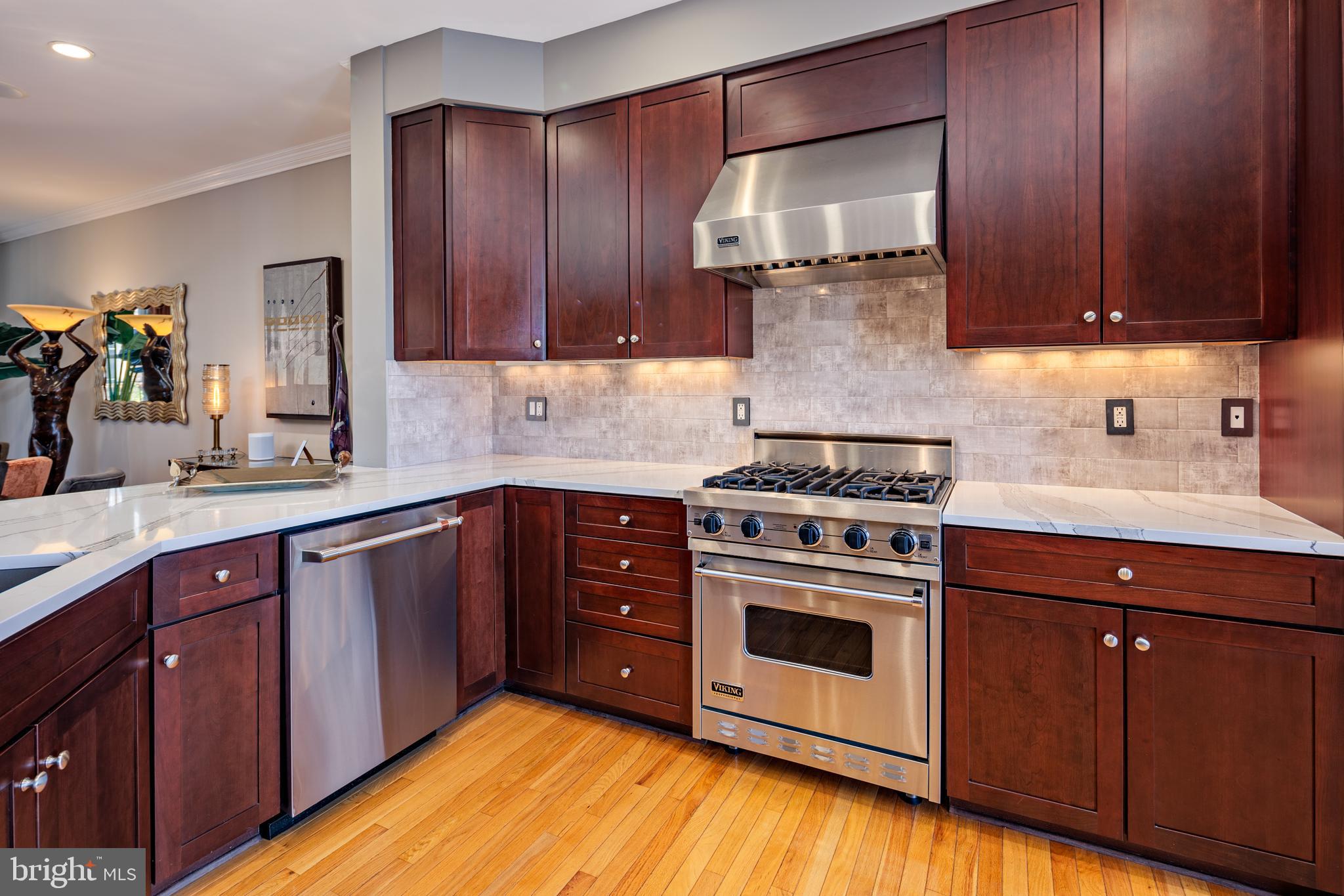 2317 Boston Street, Unit 3 Baltimore, MD 21224 - Photo 5 of 51 a kitchen with wooden cabinets and a stove top oven